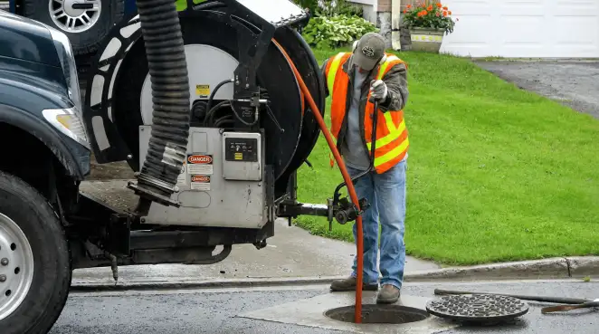Technician using specialized drainage equipment for sewer line cleaning and foundation protection in Columbus, OH