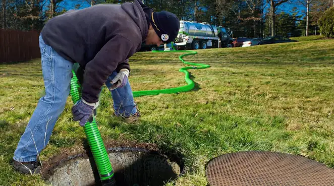 Service technician performing residential septic pumping and drainage maintenance in Columbus, OH